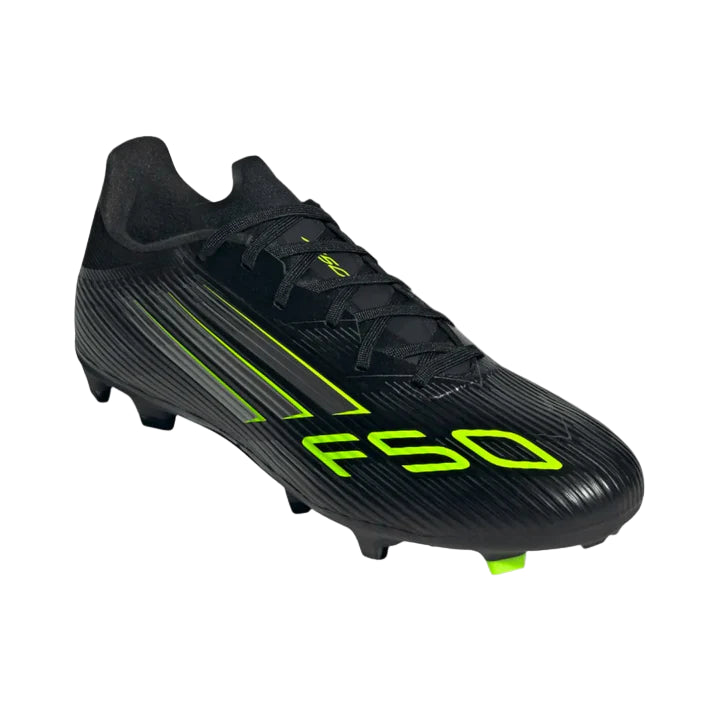 Black soccer cleat with green accents on a white background