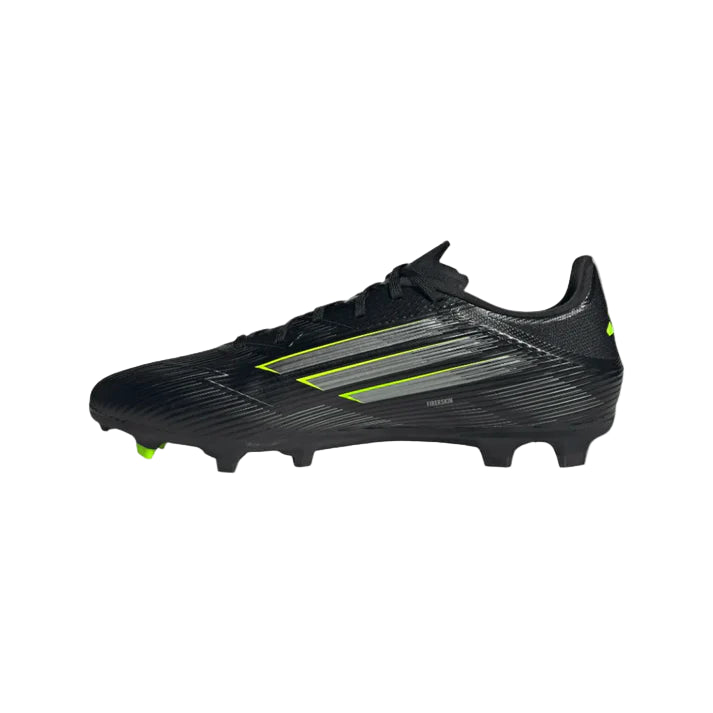 Black soccer cleat with green accents on a white background